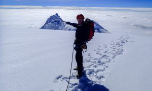 Climber on top of the stunning Antisana Volcano after a succesful alpine mountain climbing attempt at the volcano